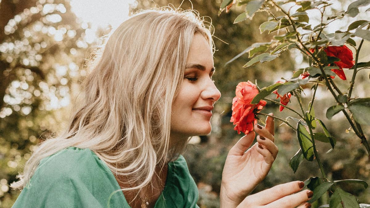 Woman Smelling Roses